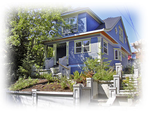 Splendid view of rental home with a light blue siding and shaded by a tree.
