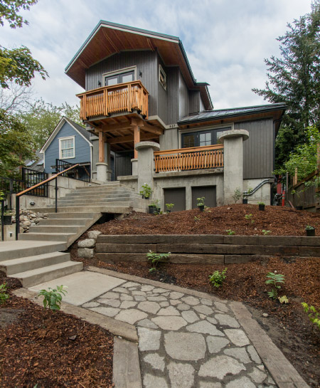 A diptych showing an exterior view of a modern home on a hill with a stone and concrete walkway and steps.
